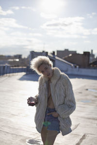 Full length of woman standing on snow against sky