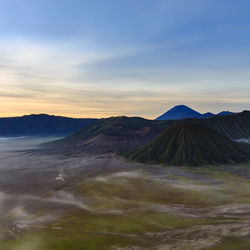 View of volcanic landscape against sky during sunset