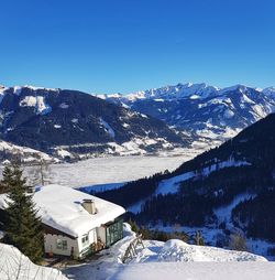 Scenic view of snowcapped mountains against clear blue sky