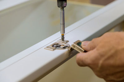 Close-up of hand installing furniture