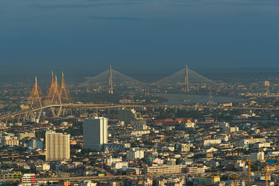 Aerial view of city lit up at riverbank