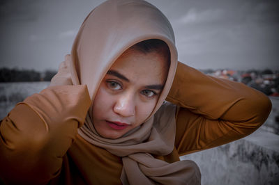 Portrait of beautiful young woman standing outdoors