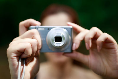 Close-up of woman holding camera