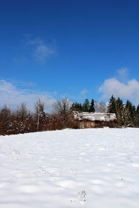 Snow covered field against sky