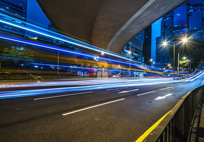 Light trails on bridge in city at night