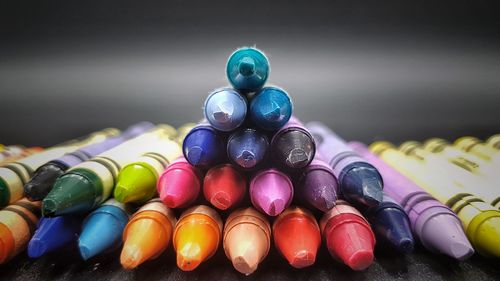 Close-up of multi colored pencils on table