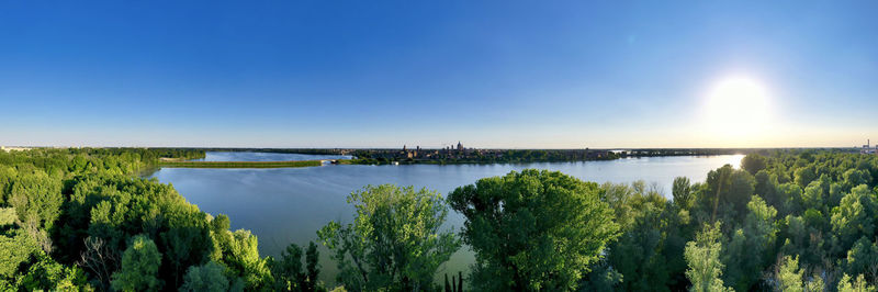 Scenic view of river against blue sky