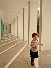 Full length of baby boy running in corridor