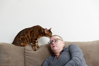 Woman with cat on sofa