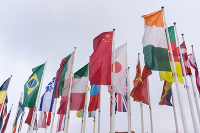 Low angle view of flags against clear sky