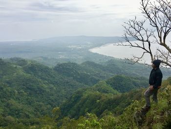 High angle view of man looking away while standing on mountain