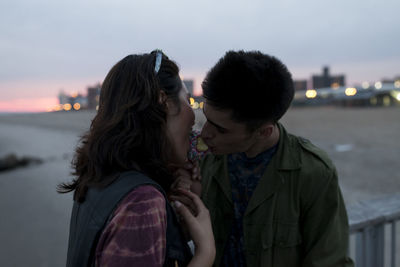 Young couple sharing a candy apple