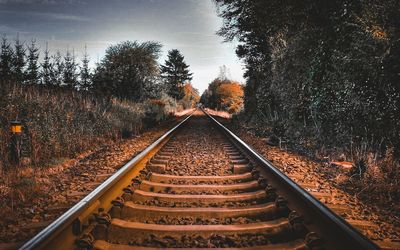 View of railroad tracks against sky during autumn