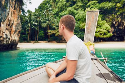 Man sitting in boat on sea