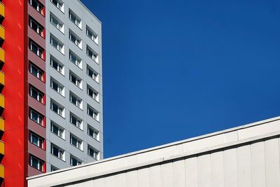 Low angle view of buildings against clear blue sky