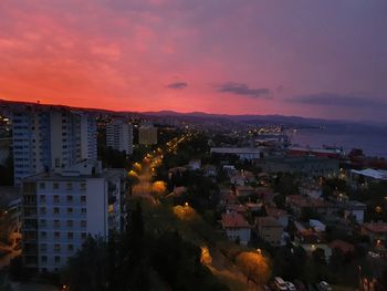 High angle view of illuminated buildings against sky at sunset