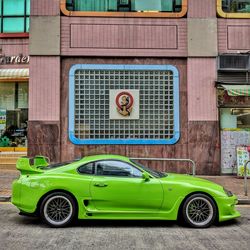 Car parked against yellow wall