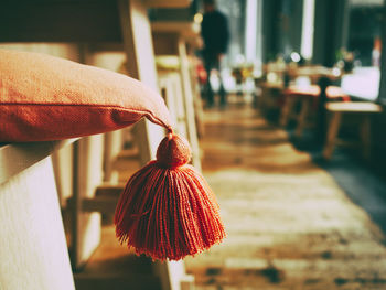 Close-up of orange pillow on stool 