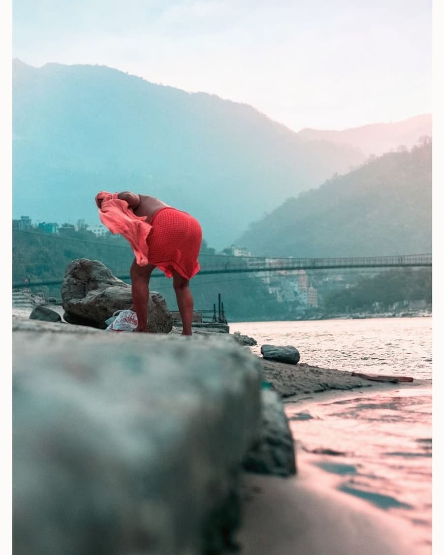 water, one person, mountain, real people, rock, nature, beauty in nature, lake, standing, day, solid, full length, scenics - nature, rock - object, lifestyles, tranquility, leisure activity, tranquil scene, outdoors