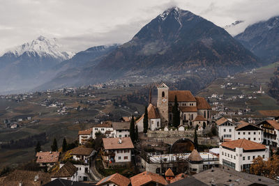 High angle view of townscape and mountains against sky