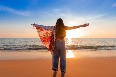 Women wearing native cloth shirts revel in the celebration of at sunset, stand in cheerfulness 