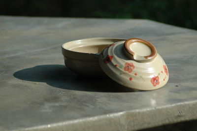 Close-up of ceramic bowl with lid on table