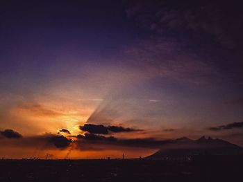 Silhouette landscape against scenic sky