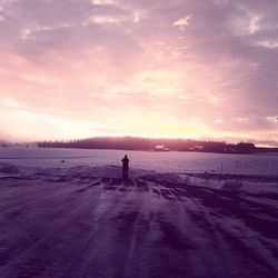 Snow covered landscape at sunset