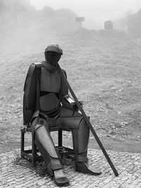 Rear view of man sitting on bench