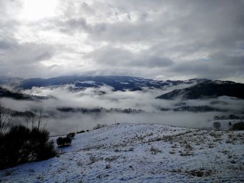 Scenic view of snow covered mountains against sky