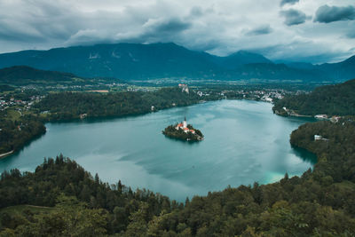 High angle view of bay and mountains against sky