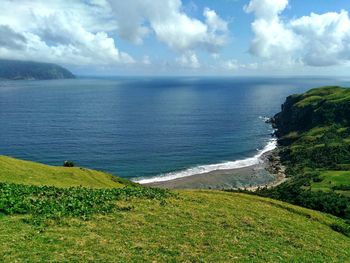 Scenic view of sea against cloudy sky