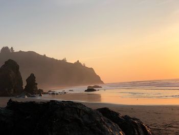 Scenic view of sea against clear sky during sunset
