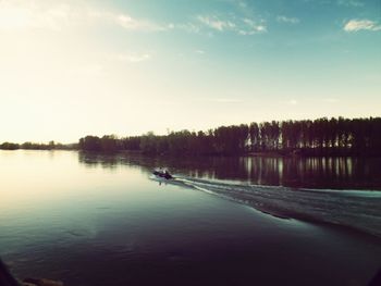 Scenic view of river against sky at dusk