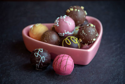 Pink heart dish with delicious chocolate truffles