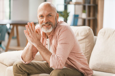 Young man sitting on sofa at home