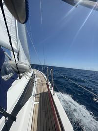 Sailboat sailing in sea against sky