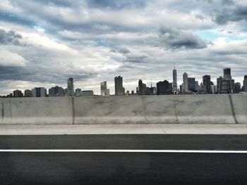 City skyline against cloudy sky