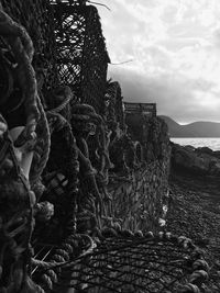 Crab pots at sea shore against sky