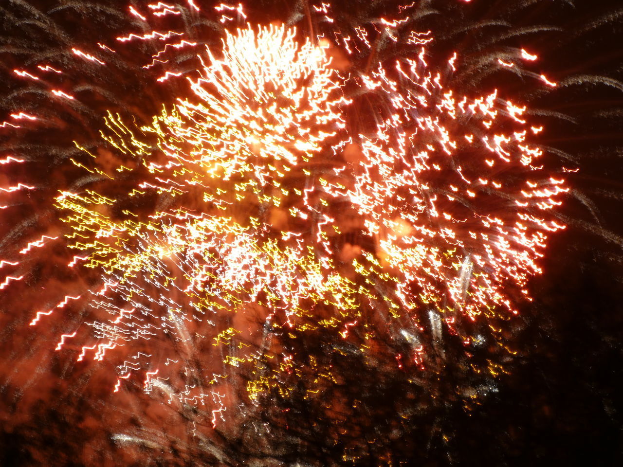 LOW ANGLE VIEW OF FIREWORK DISPLAY IN SKY