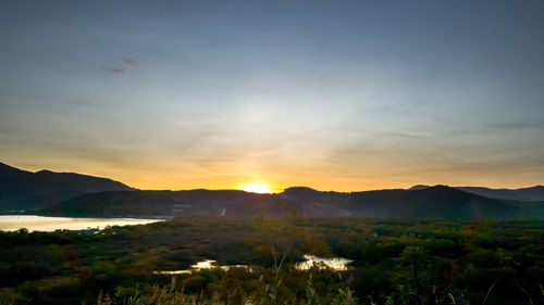 Scenic view of silhouette mountains against sky during sunset