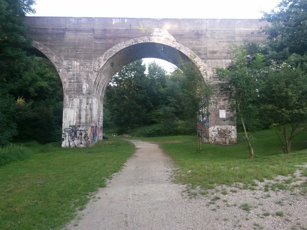 VIEW OF BRIDGE LEADING TOWARDS TREES