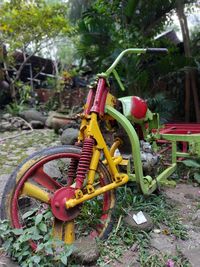 Close-up of abandoned bicycle on field