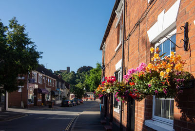 Street amidst buildings against clear sky