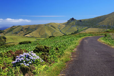 Scenic view of mountains against blue sky