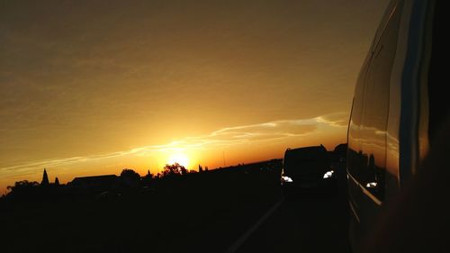 Cars on road against sky at night