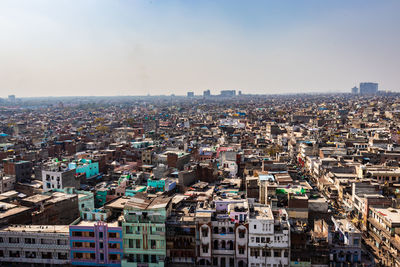 Crowded city construction with flat hazy sky at morning from unique angle