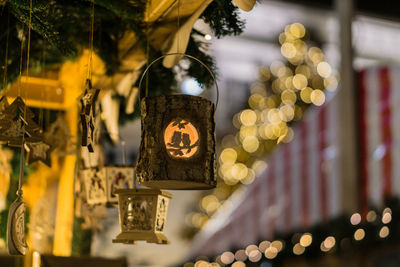 Low angle view of illuminated decorations hanging from roof during christmas