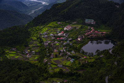 High angle view of trees and buildings against mountains