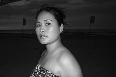 Portrait of woman on beach against sky